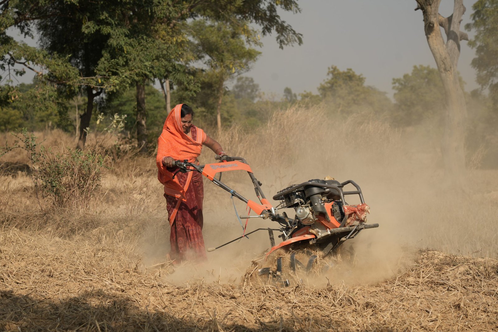 Farmer using farm machinery for agricultural land preparation